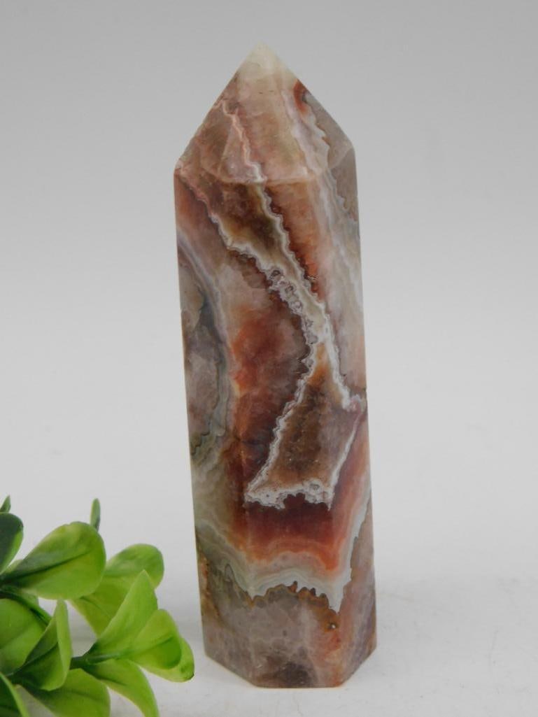 Agate Crystal Point Tower Rock Stone Lapidary Specimen: - Polished agate crystal in a pointed tower shape. | - Intricate natural patterns with shades of red, brown, white, and cream. | - Dimensions and weight are shown near a ruler for reference. | - Lot n