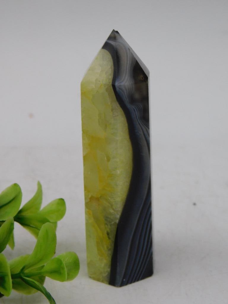 Agate and Quartz Tower, 65 Grams Rock Stone Lapidary Specimen: - A polished tower featuring a combination of black banded agate and yellow quartz. | - Weighs approximately 65 grams, as indicated on the label. | - Tapered to a point, suitable for display or collec