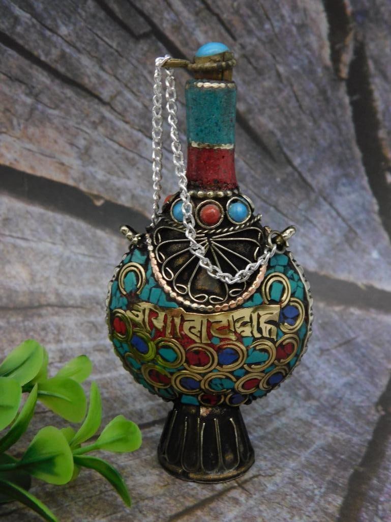 Tibetan-Style Decorative Snuff Bottle with Stones: - Decorative Tibetan-style perfume bottle with intricate detailing | - Adorned with colorful stones in red, blue, and turquoise hues | - Features a chain-anchored stopper with a blue stone accent | - 