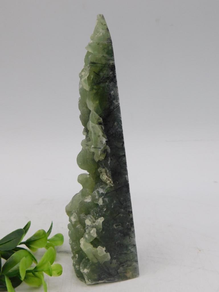 Prehnite Rock Stone Lapidary Specimen: - Natural green quartz crystal specimen with unique freeform shape. | - Contains visible inclusions and varying textures that highlight the natural formations of the stone. | - Dimensions and weight s