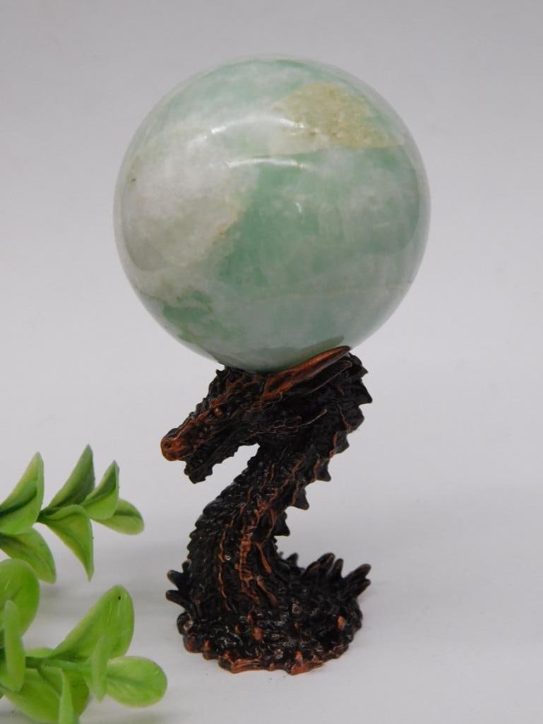 Amazonite Sphere With Dragon Stand Rock Stone Lapidary Specimen: - Includes a polished green gemstone sphere with natural patterns. | - Comes with a detailed resin dragon stand, designed to securely hold the sphere. | - Total weight indicated as 153 grams. | - Sphe