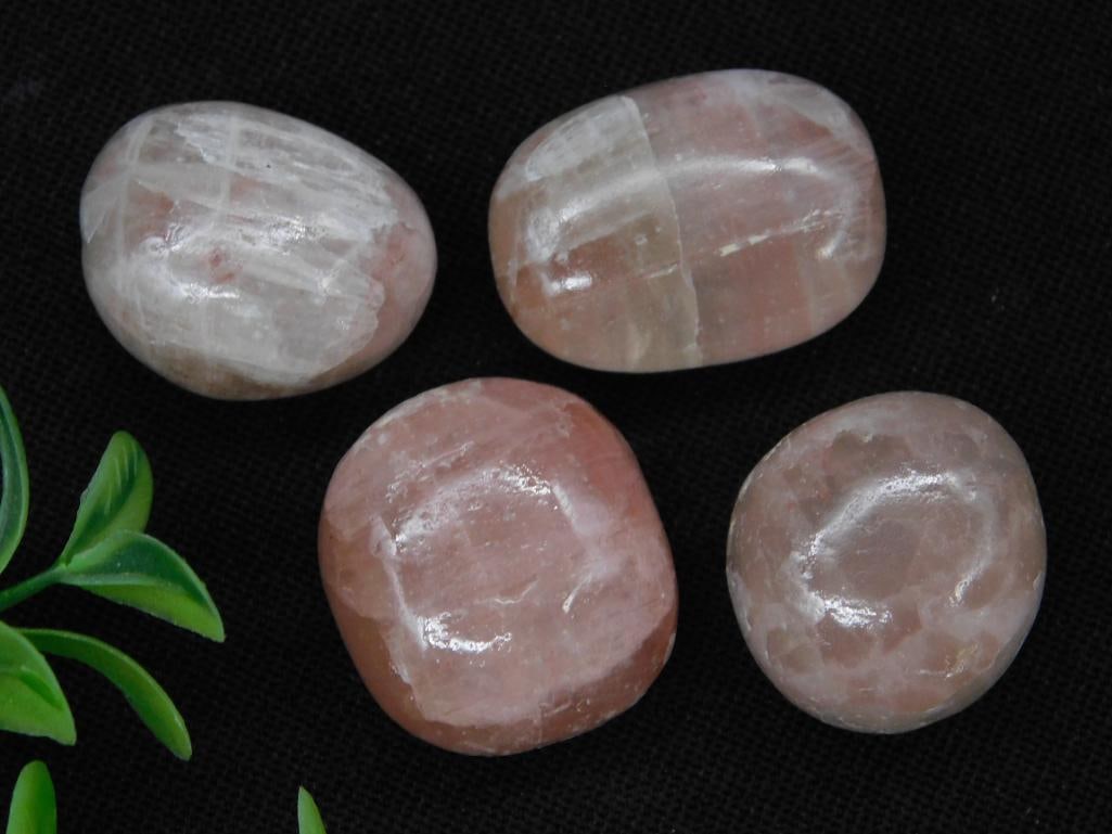 Four Polished Rose Quartz Stones Rock Stone Lapidary Specimen: - Includes four polished rose quartz stones with smooth, rounded surfaces. | - Light pink hues with natural variations and translucence. | - Total weight of stones is 62 grams as displayed. | - Coin s