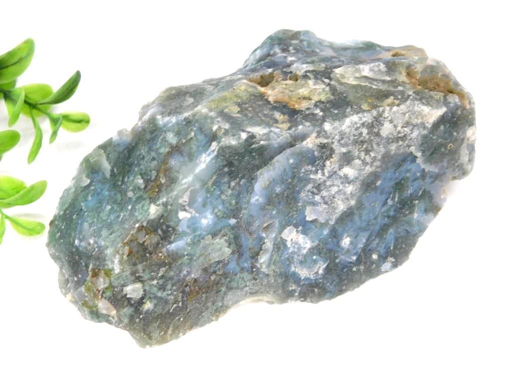 Moss Plume Agate Rock Stone Lapidary Specimen: - Raw rock specimen featuring a mix of colors, predominantly green, blue, and gray. | - Natural, unpolished surface with varying textures and mineral inclusions. | - Weight: 1 pound, 2.7 ounces (per l