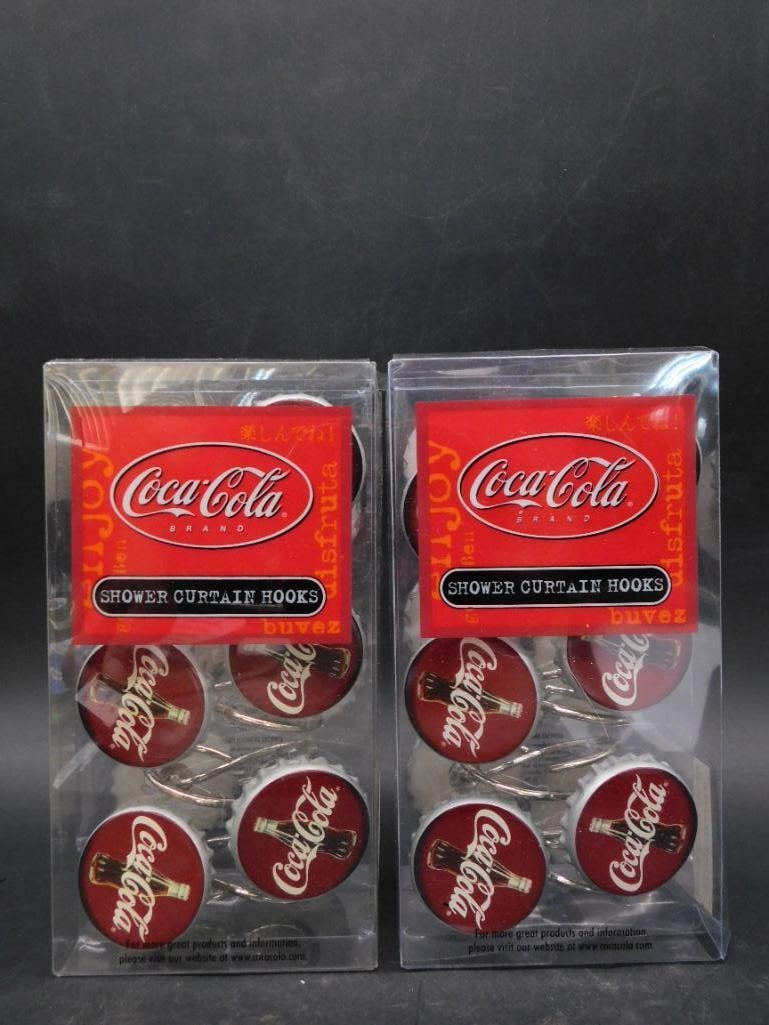 Coca-Cola Vintage Shower Curtain Hooks (2 New Sets): - Two sets of Coca-Cola branded shower curtain hooks. | - Each set contains multiple hooks featuring the iconic Coca-Cola logo and design. | - Hooks are new and still sealed in original packaging. | -