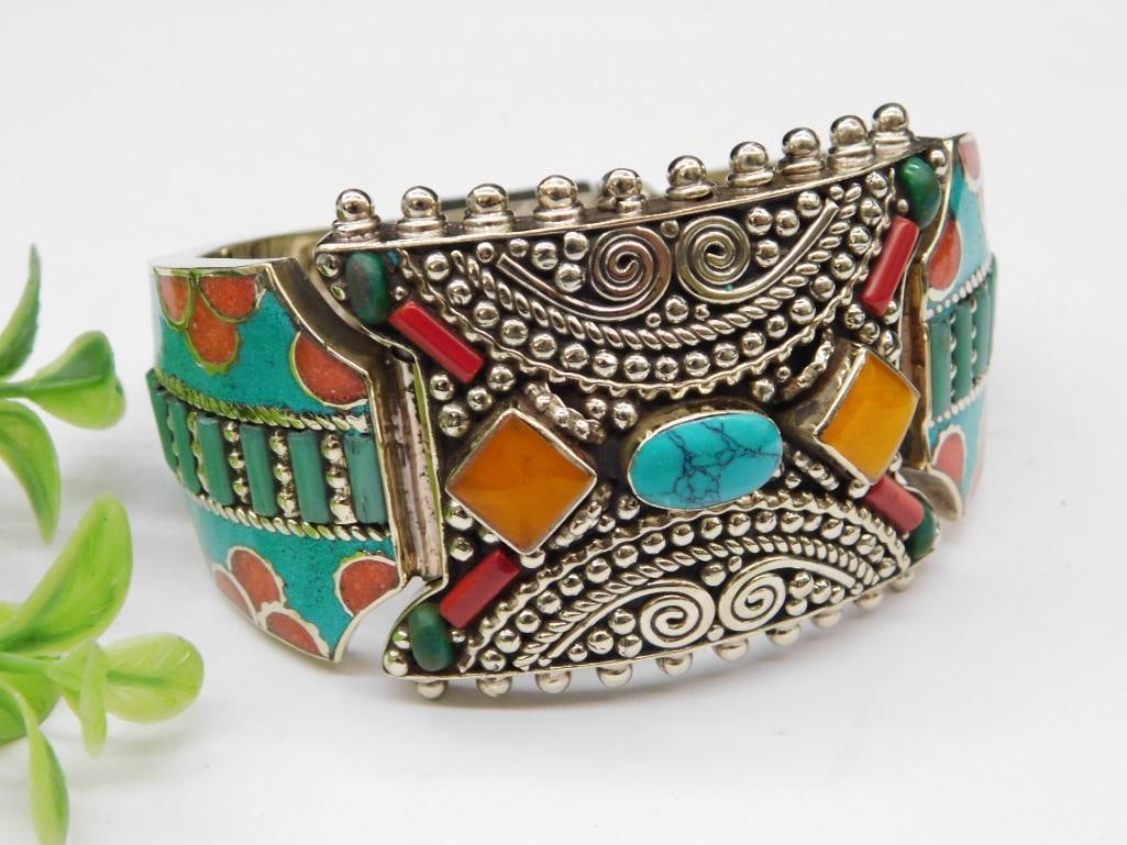 Silver-Tone Hinged Bracelet With Turquoise, Red Coral, and Carnelian: - Silver-tone bracelet featuring hinged closure for easy wear. | - Decorated with colorful inlays, including turquoise, orange, and red resin stones. | - Intricate textured designs with beadwork patte