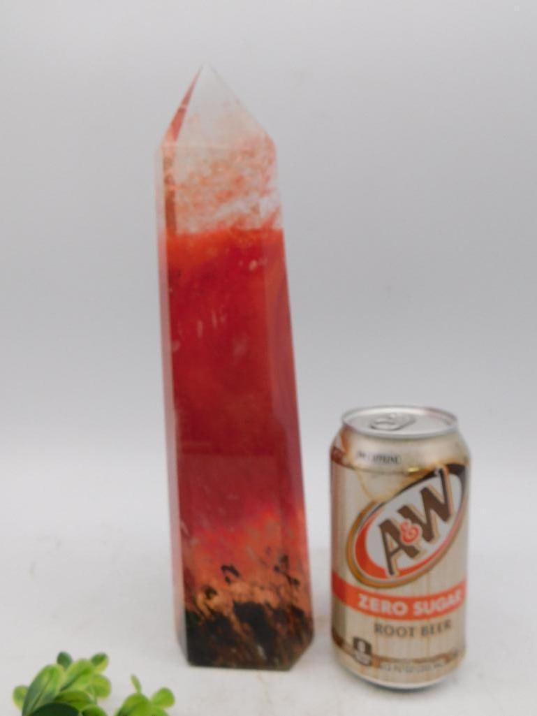 Red And Black Stone Tower Rock Stone Lapidary Specimen: - Polished gemstone tower with vibrant red and black hues. | - Features a pointed tip and flat base for stable standing. | - Measures approximately 8 inches tall (confirmed by ruler in image). | - Inc