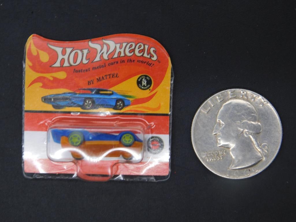 Worlds Smallest Hot Wheels By Mattel Blue-and-Orange Car in Original Packaging: Hot Wheels die-cast toy car by Mattel in its original unopened packaging. Features a blue-and-orange car design with green wheels. The front of the packaging displays 'Hot Wheels' branding and the mod