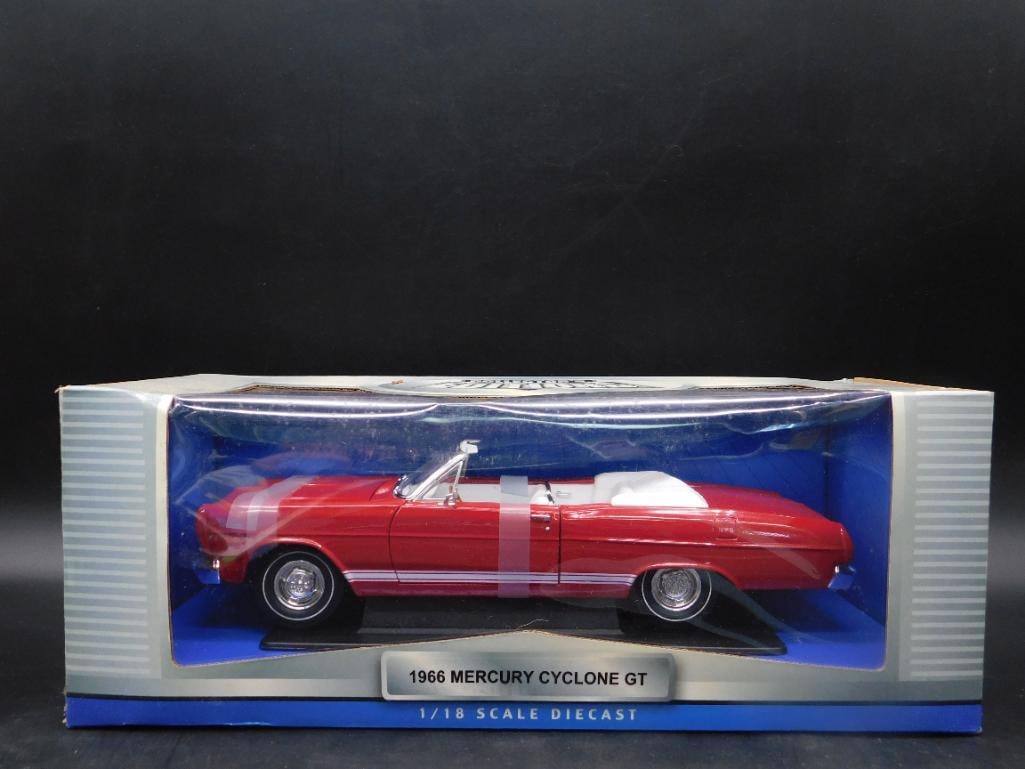 1966 Mercury Cyclone GT 1:18 Scale Diecast Model: Collector's edition 1966 Mercury Cyclone GT diecast model in 1:18 scale. Features a red body with a white interior. Item is in its original packaging, which shows minor wear. Model includes detailed i