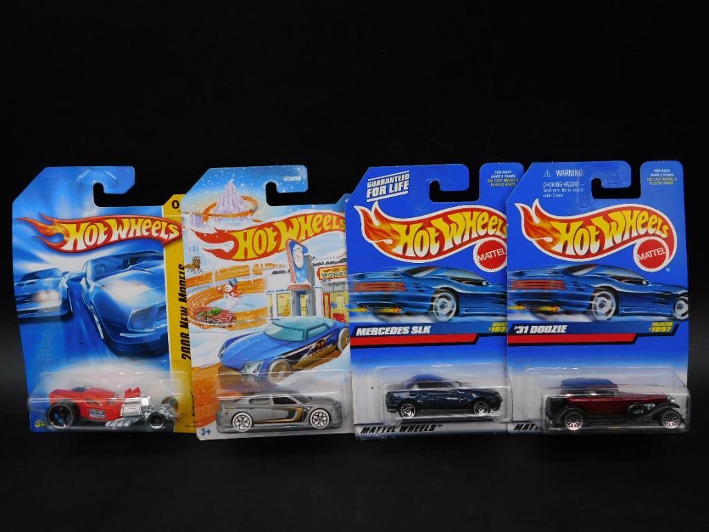 Lot of 4 Hot Wheels Die-Cast Cars in Original Packaging: This lot includes four Hot Wheels die-cast cars, each in its original packaging. The cars feature a variety of designs and themes, as shown. Packaging indicates series information, with detailed descr