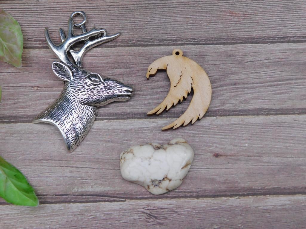Lot of 3 Pendant Accessories With Deer, Moon, and Stone: - Includes 3 unique items: one silver-tone deer head pendant, one carved wooden crescent moon pendant, and one white stone heart-shaped piece. | - Deer pendant appears to feature detailed antlers and 