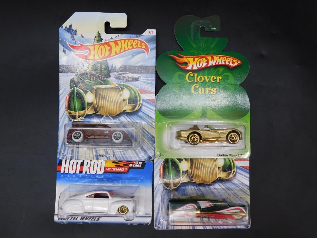 Lot of 4 Hot Wheels Cars: Holiday Themes & Clover Cars: This lot includes four Hot Wheels cars in original packaging. The set features Holiday Hot Rods and Clover Cars series, including Dodge Viper RT/10, Screamin? Hauler, and additional unique models. Pac