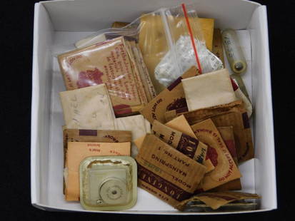 Vintage Parts in Original Packaging WATCHMAKER WATCHMAKING TOOLS: A collection of vintage parts, some sealed in their original packaging. | - Includes packets from various manufacturers, featuring historical designs and branding. | - Items appear to be from mid-20th
