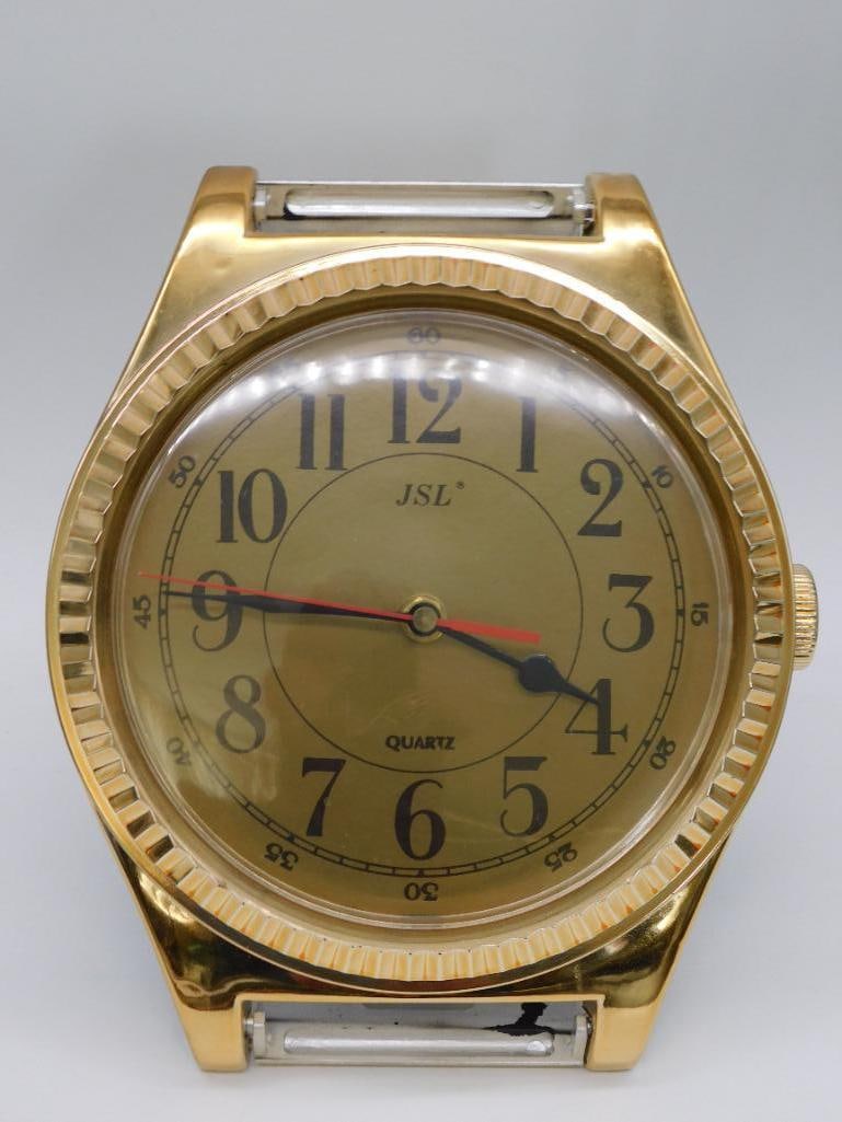 J.S.L. Inc. Gold-Tone Quartz Wristwatch, Made in Taiwan: - Gold-tone quartz wristwatch by J.S.L. Inc. | - Dial features black numerals with a red seconds hand | - Branded 'J.S.L. INC.' on dial and inside the strap | - Includes a metallic expansion band | -