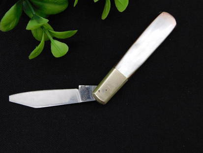 Vintage Folding Pocket Knife with Mother of Pearl Handle: - Vintage folding pocket knife featuring a sleek design. | - Handle crafted from mother of pearl material, offering a polished finish. | - Blade made of surgical steel, marked "Japan" for origin. | -