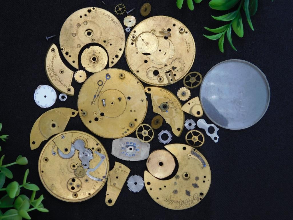 Vintage Watch Movement Parts WATCHMAKER WATCHMAKING TOOLS: - Includes multiple vintage watch movement parts, gears, and plates. | - Some pieces are marked "American Watch Co." and "June 16, 1885." | - Circular glass and other small fittings are part of the lo