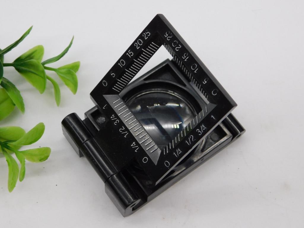 Folding Magnifier with Built-in Measuring Scale WATCHMAKER WATCHMAKING TOOL: - Portable folding magnifier with built-in lens for close-up inspection. | - Features a measuring scale engraved on the frame, marked in inches and centimeters. | - Compact folding design for easy sto