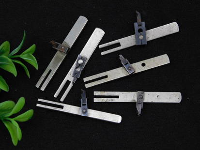 6 Vintage Metal Sewing Machine Attachments WATCHMAKER WATCHMAKING TOOL: - Includes 6 metal sewing machine attachments or parts. | - Each piece features a metallic finish with varying designs. | - Designed for use in older or vintage sewing machines. | - Condition shows so