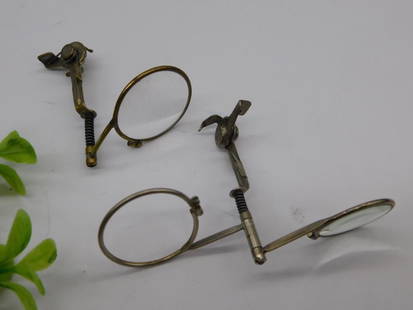 Antique Clip-On Magnifying Glass Lenses with Mechanism WATCHMAKER WATCHMAKING TOOL: - Pair of antique clip-on magnifying glasses | - Features a compact foldable mechanism | - Metal construction with spring-loaded clips | - Round lenses designed for magnification purposes | - Small si