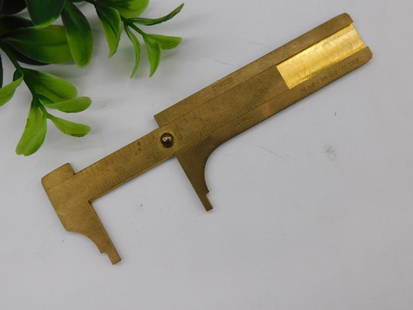 Vintage Brass Sliding Caliper ? Made in Germany WATCHMAKER WATCHMAKING TOOL: - Brass-made sliding caliper with etched measurement markings in millimeters and inches. | - Clearly marked 'Made in Germany' on the body. | - Compact design ideal for precise measurement tasks. | -