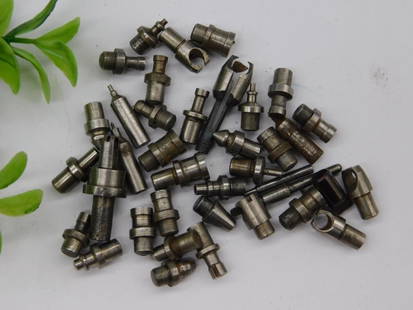 Small Metal Machined Parts for Various Uses WATCHMAKER WATCHMAKING TOOL: - Collection of assorted small metal machined parts, totaling 40+ pieces. | - Includes various shapes such as cylindrical, rounded, and tapered designs. | - Pieces feature holes, threading, and