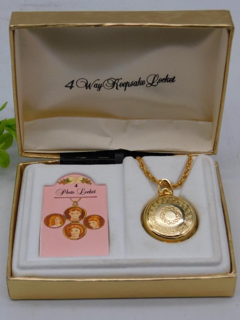 Gold-Tone 4-Way Expandable Photo Locket Necklace WATCHMAKER WATCHMAKING TOOLS: - Gold-tone round locket with an ornate design and black embellishment in the center. | - Features a unique 4-way expandable mechanism to hold multiple photos. | - Comes with a matching gold-tone chai