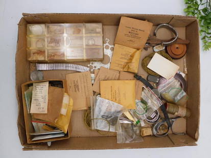 Vintage Watchmaking Parts and Tools WATCHMAKER WATCHMAKING TOOLS: - Includes assorted vintage watch parts stored in plastic containers and envelopes. | - Tools and accessories for watchmaking, including winding tools, gears, springs, and measuring devices. | - Origi