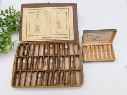 Antique Swartchild Watch Parts Kits WATCHMAKER WATCHMAKING TOOLS: - Includes two cases containing assorted watch parts from Swartchild & Co. | - Larger case marked "Assortment No. 14533" with labeled compartments, housing various parts. | - Smaller case includes gla