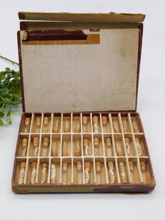 Vintage Watch Pieces in Vial Collection in Case WATCHMAKER WATCHMAKING TOOLS: Includes 28 small glass vials with cork stoppers, labeled with various substances in handwritten text. | Case features a compartmentalized interior to securely hold the vials. | Exterior of the case i