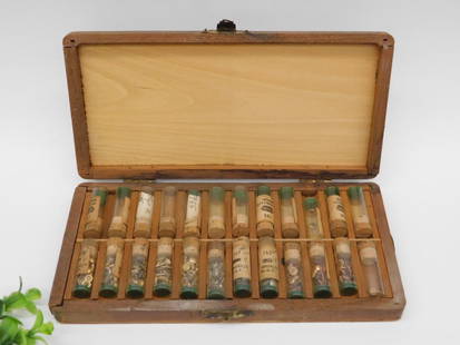 Wooden Case with Vials Containing Various Metal Parts WATCHMAKER WATCHMAKING TOOLS: Wooden storage case with hinged lid and latch closure. | Contains multiple glass vials with cork stoppers. | Each vial appears to hold assorted small metal parts, including screws and washers. | Vials