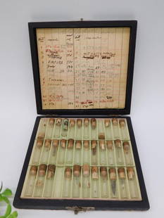 Vintage Wooden Case With Numbered Glass Vials WATCHMAKER WATCHMAKING TOOLS: Vintage wooden case with a hinged lid and metal latch closure. | Contains multiple glass vials with cork stoppers, each numbered and some with visible contents. | Includes an inserted chart displaying