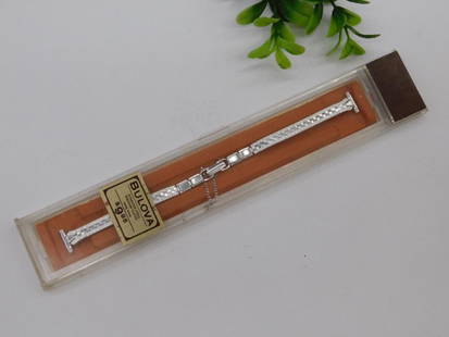 Bulova Stainless Steel Ladies Watch Band in Original Box WATCHMAKER WATCHMAKING TOOLS: Brand: Bulova | Material: Stainless steel | Style: Ladies watch band | Features a fold-over clasp with attached safety chain | Includes original box with a clear lid and orange base | Condition: