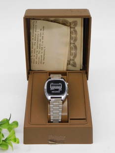 Vintage Netronic Digital LCD Watch with Original Case WATCHMAKER WATCHMAKING TOOLS: Vintage Netronic brand digital LCD wristwatch. | Features a classic rectangular face with digital time display. | Stainless steel bracelet with a polished finish. | Comes with original brown storage