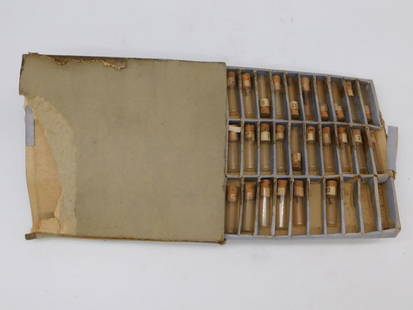 Vintage Set of Glass Vials with Cork Stoppers WATCHMAKER WATCHMAKING TOOLS: Includes a collection of numbered glass vials with cork stoppers organized in a partitioned box. | Box is constructed from lightweight material with significant wear and damage, including torn edges.