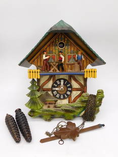 Vintage West German Cuckoo Clock with Dancing Figures WATCHMAKER WATCHMAKING TOOLS: Vintage cuckoo clock crafted in West Germany. | Features a chalet-style wooden design with hand-painted accents. | Includes a working clock face with Roman numerals and two pine cone weights. | Detail