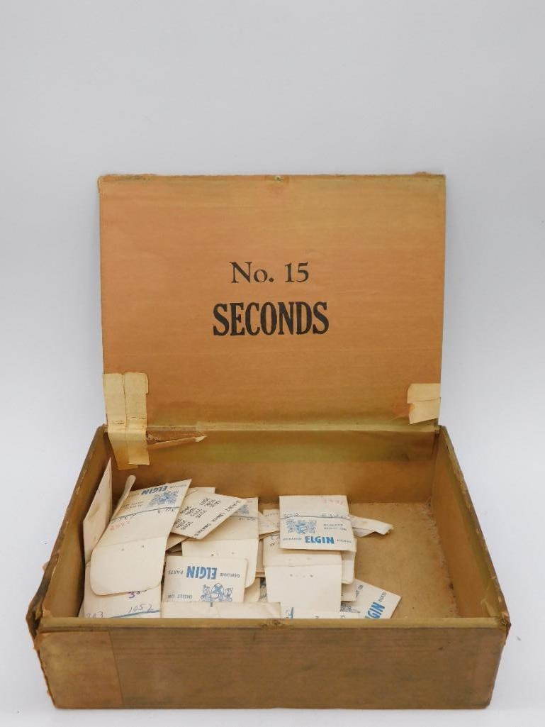 Vintage Elgin Watch Parts in Box No. 15 Seconds WATCHMAKER WATCHMAKING TOOLS: Includes a vintage cardboard box labeled "No. 15 Seconds." | Contains various envelopes marked with "Genuine Elgin Parts" and other handwritten notes. | Appears to hold numerous small watch components