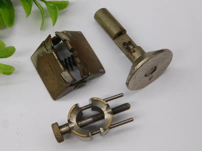 Vintage Machinist Tools and Attachments WATCHMAKER WATCHMAKING TOOLS: - Lot includes three vintage machinist tools or attachments, as shown in images.n- One tool features a square metal housing with internal spring mechanism.n- Another piece appears to be a cylindrical