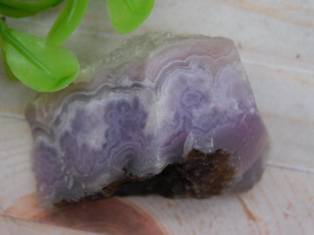 LUNA AGATE ROCK STONE LAPIDARY SPECIMEN: - Natural purple banded agate specimen showcasing layered patterns. | - Weight: 30 grams, as labeled. | - Features subtle lavender, purple, and white hues. | - Unpolished condition with rough natural
