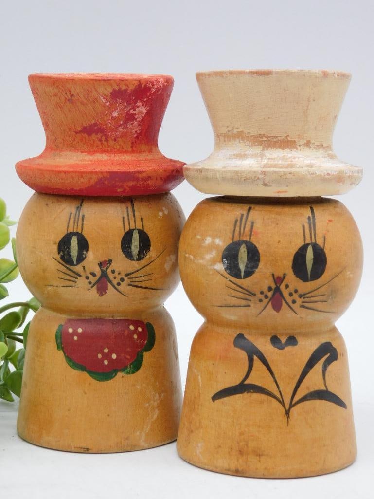 Vintage Cat-Themed Salt and Pepper Shakers: - Pair of vintage salt and pepper shakers crafted from wood. | - Features hand-painted cat-themed designs on both shakers. | - Shakers include removable tops with multiple holes for dispensing. | - Ap