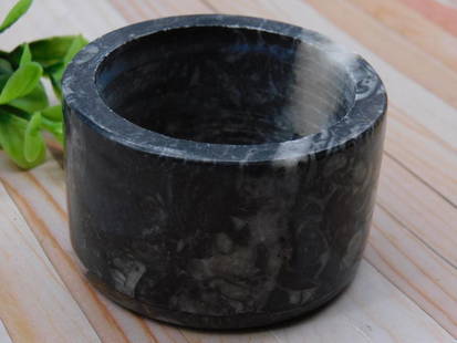 ORTHOCERAS TRINKET BOX ROCK STONE LAPIDARY SPECIMEN: - Material: Black polished stone with natural veining and patterns. | - Dimensions: Approximately 3 inches in diameter as shown next to the ruler. | - Condition: Appears to have a smooth interior and