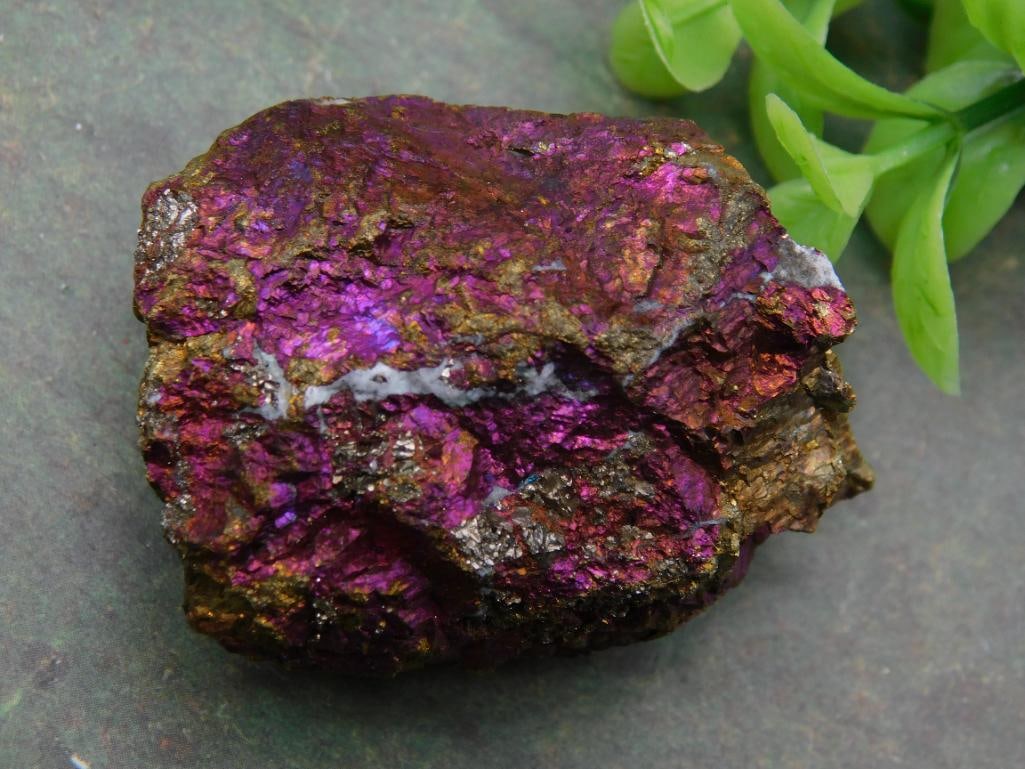 PEACOCK ORE ROCK STONE LAPIDARY SPECIMEN: - Specimen rock with vibrant metallic purple hues and natural textures. | - Approximate weight: 70 grams (detailed on included label). | - Lot details: Auction year 2025, Lot #710128. | - Included wit