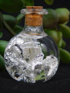 Small Bottle of Real Silver Flakes ROCK STONE LAPIDARY SPECIMEN: - Small glass bottle with cork stopper containing real silver flakes | - Included label clearly stating 'Real Silver Flakes' | - Measuring ruler shown for size overview (exact dimensions unknown) | -