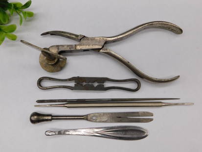Vintage Medical or Dental Tools Collection WATCHMAKER WATCHMAKING TOOLS: - A lot consisting of six vintage medical or dental tools. | - Includes pliers-like tool with wire mechanism, small flat instrument, and various others. | - Constructed from metal with visible age and