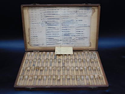 Vintage Wooden Case with Vials and Label Chart WATCHMAKER WATCHMAKING TOOLS: - Wooden case containing numerous glass vials with numbered labels. | - Vials appear to contain various small metal objects or components. | - Inside lid features a detailed numbered chart with handwr