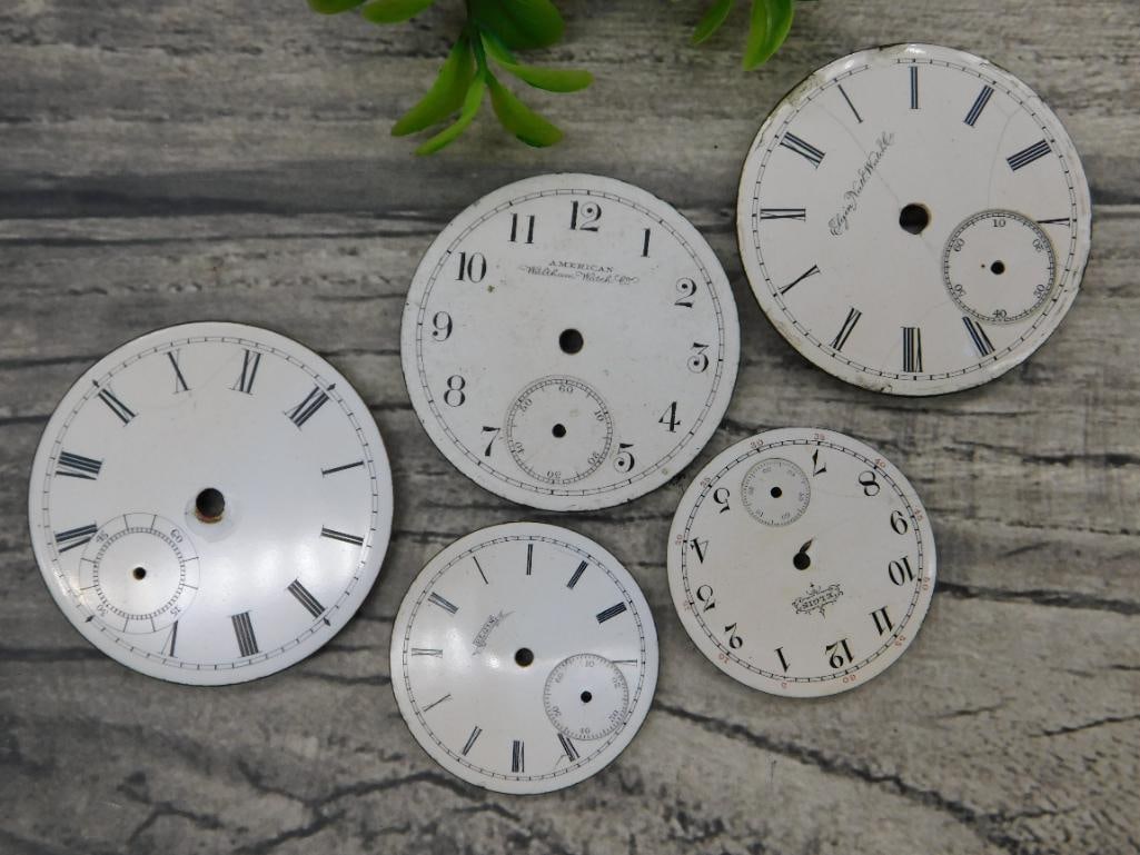 5 Vintage Porcelain Pocket Watch Dials: Includes 5 porcelain pocket watch dials with various designs and manufacturers. | Features Roman and Arabic numerals along with sub-dials. | Brands include "American Watch Co." and others as marked on