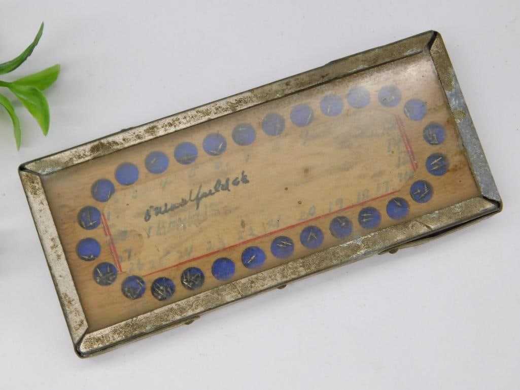 Vintage Metal and Wood Decorative Box with Blue Accents: Rectangular decorative box featuring a combination of wood and metal materials. | Top surface has a clear covering with a design incorporating blue accents and hand-drawn markings. | Signs of wear and