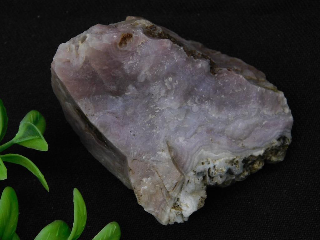Luna Agate Rock Stone Lapidary Specimen: - Material: Raw purple mineral stone, likely from a natural source. | - Weight: 109 grams. | - Condition: Natural, unpolished state with visible texture and raw edges. | - Dimensions: Not specified. |