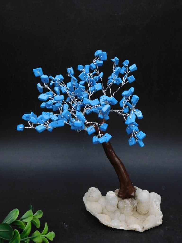 Decorative Tree With Blue Stone Leaves and Quartz Base: - Decorative tree sculpture featuring blue stone leaves attached to wire branches. | - Mounted on a natural quartz crystal base, providing a solid and aesthetic foundation. | - Stem designed with a re