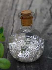 Small Glass Bottle with Silver-Colored Foil Inside