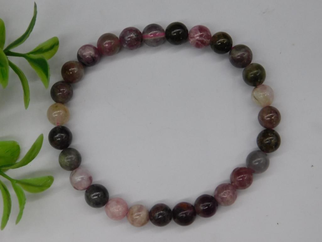 Stone Beaded Stretch Bracelet Rock Stone Lapidary Specimen: This lot features a stretch bracelet composed of polished, multicolored natural stone beads. The beads display a variety of hues, including shades of pink, green, and brown. The stones are round and u