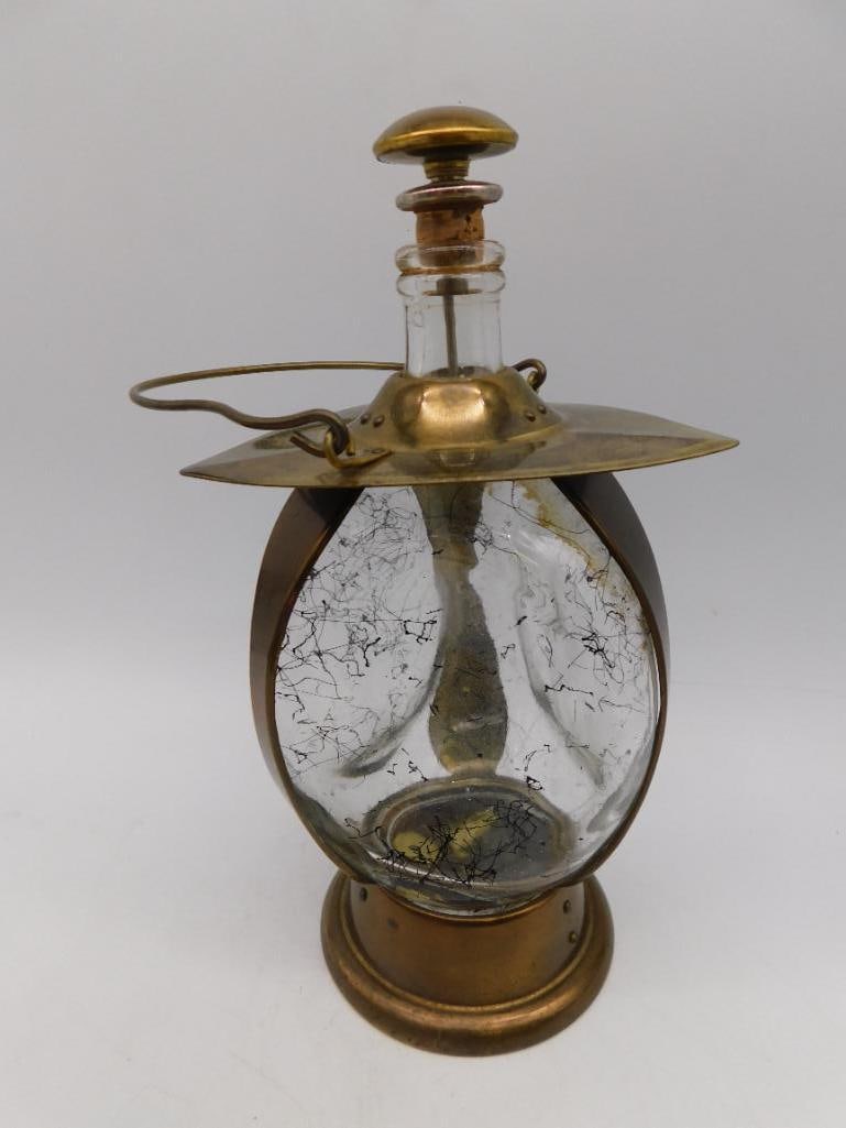 Vintage Brass and Glass Decanter Music Box MCM Mid Century: - Features a brass construction with a central clear glass body. | - Includes a removable stopper with a brass top. | - Decorative brass base and top with secure metal hinges. | - Marked "How Dry I Am